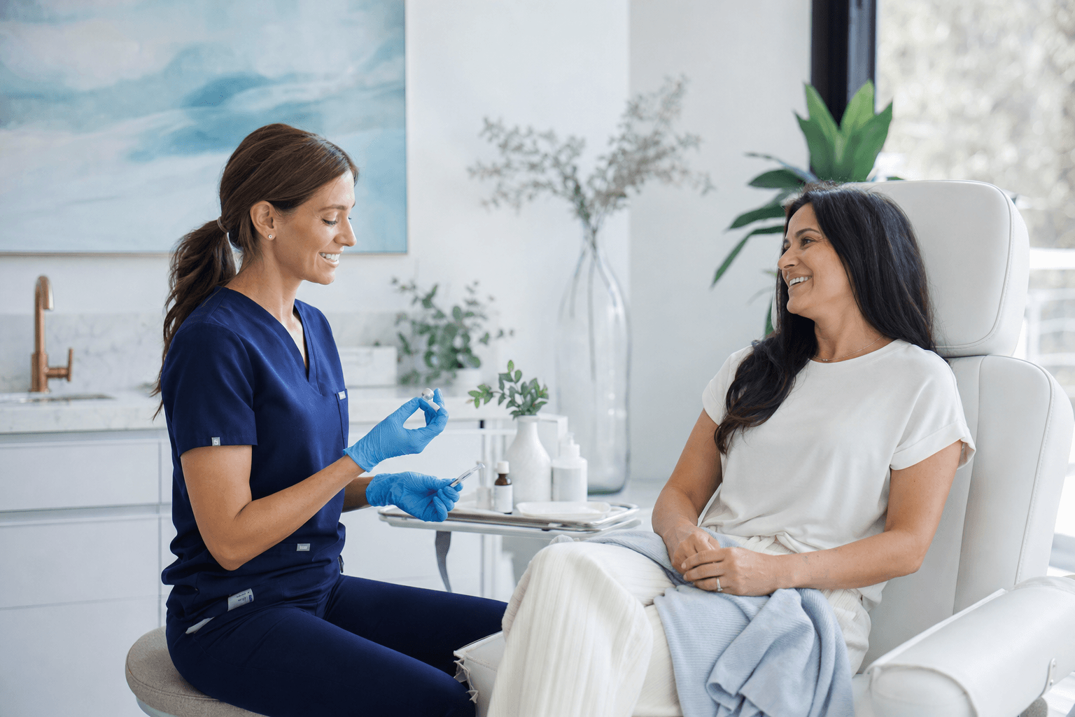 Clinician preparing a nutrient injection appointment with a relaxed patient