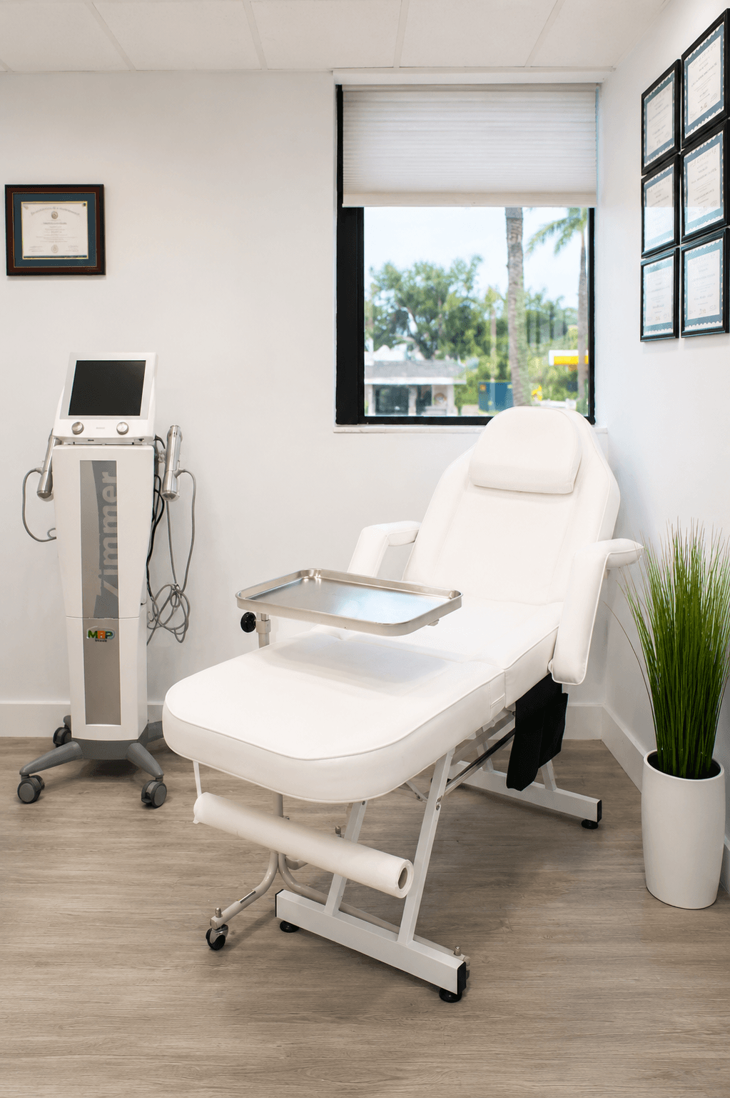Treatment room displaying professional certifications and credentials