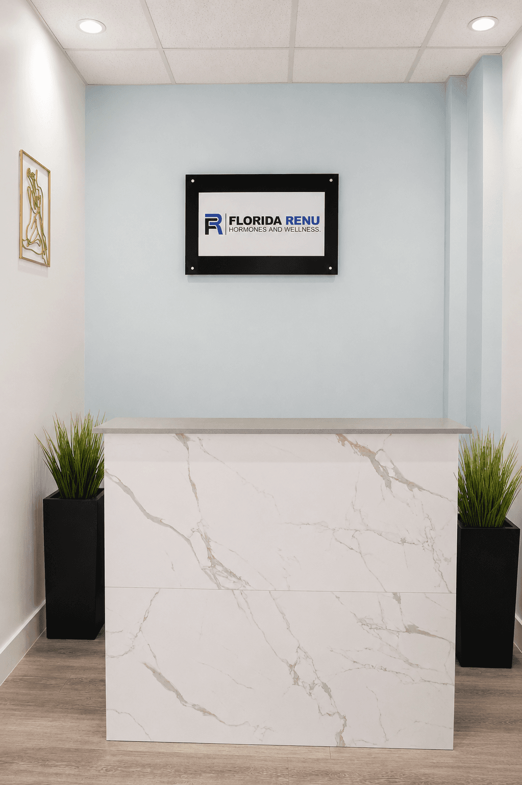 Florida Renu reception lobby with marble desk and brand signage in Hollywood, FL